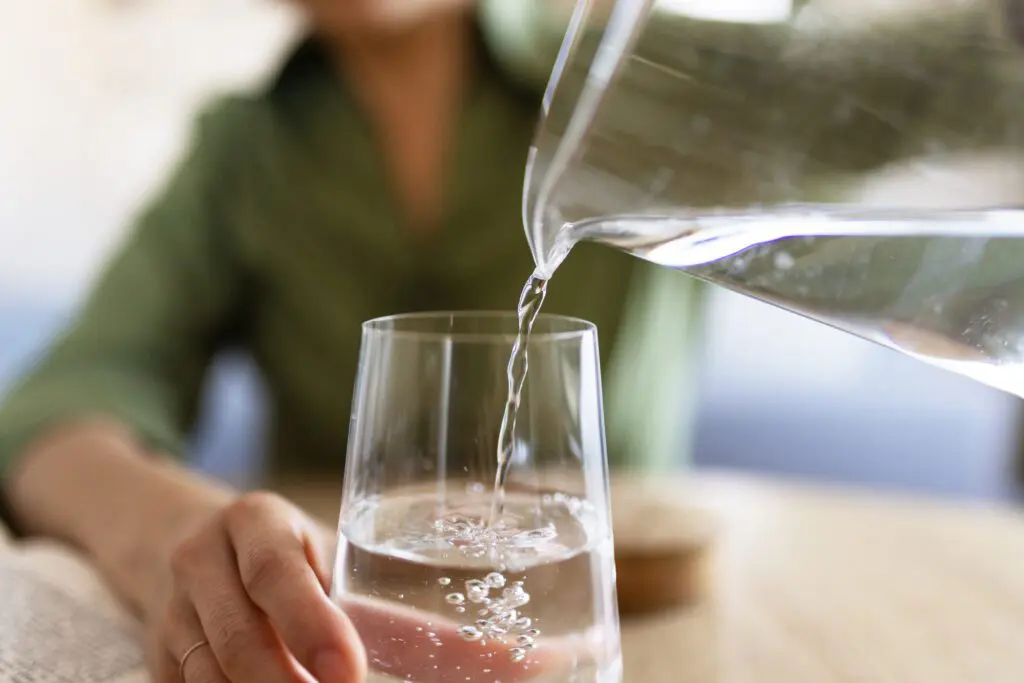 woman pouring water from jug