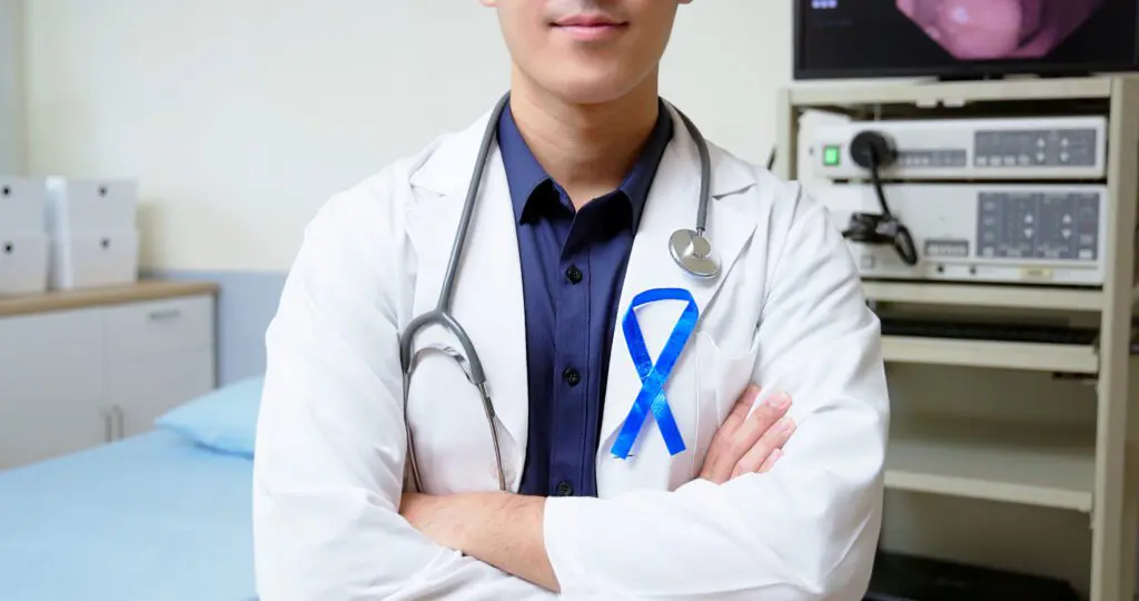 gastroenterologist in clinic wearing blue ribbon for colon cancer awareness month
